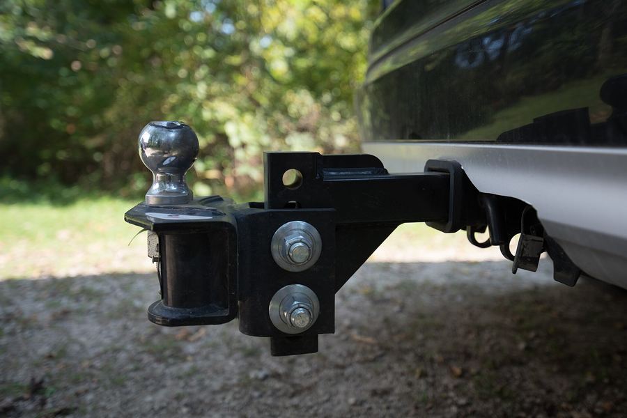 A weight distributing hitch head, showing the spring bar sockets, the adjustment bolts, the safety chain hooks and a 7-pin trailer connector